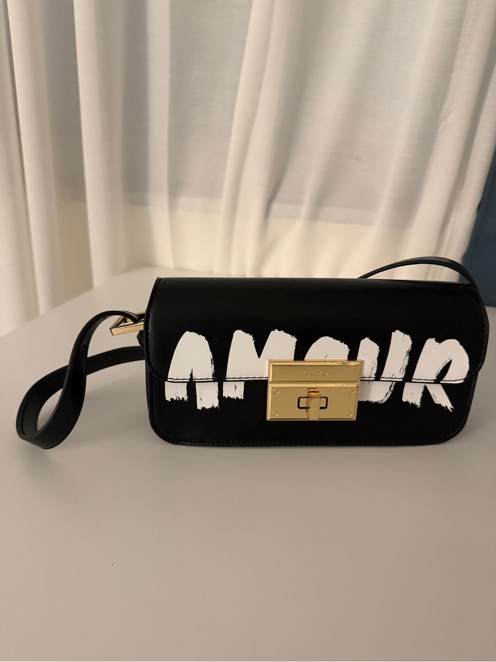 ALDO Black Leather Crossbody Bag with White Graffiti Text and Gold Hardware